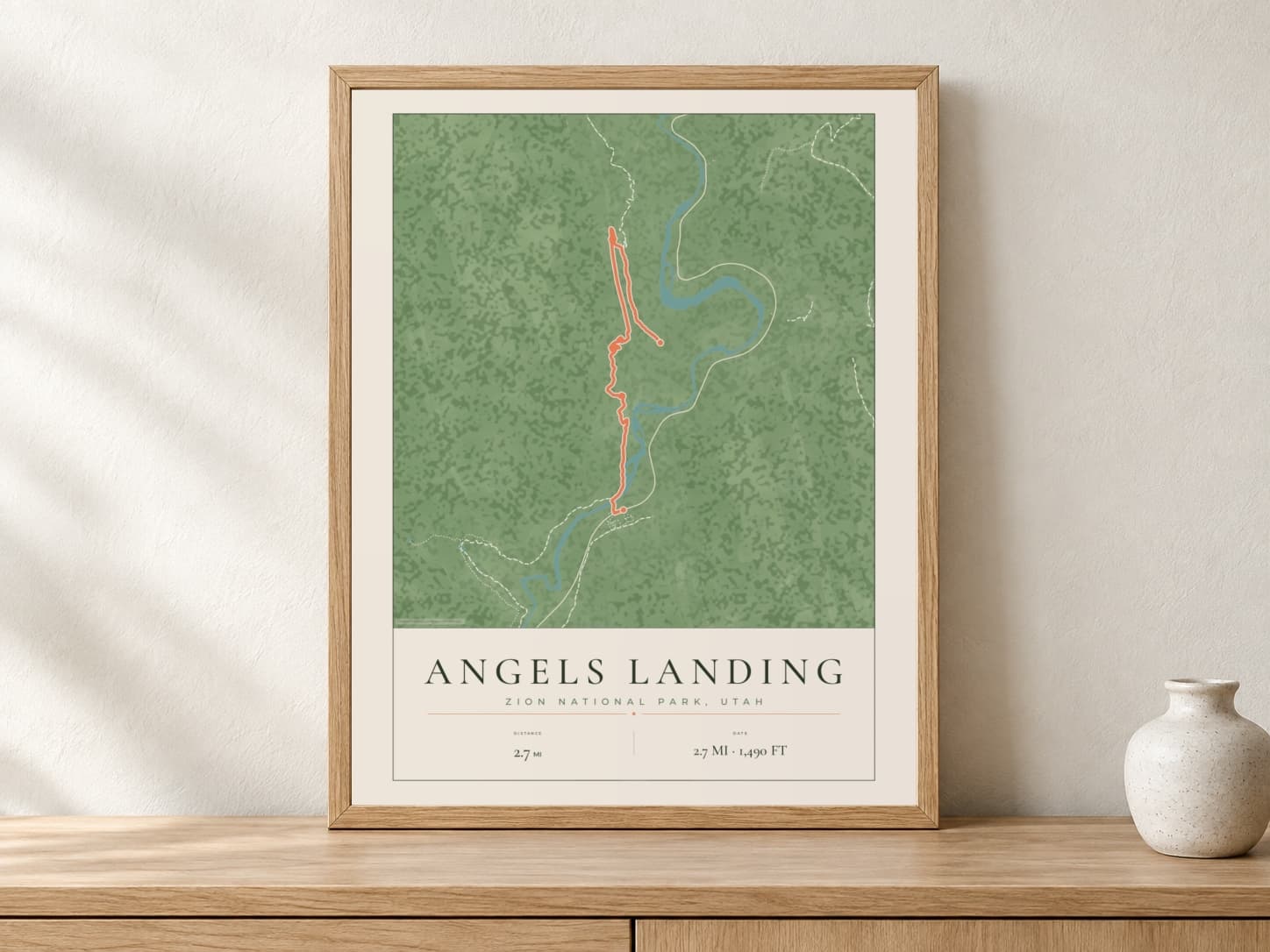 Angels Landing Parkland route print in a light oak frame on a console