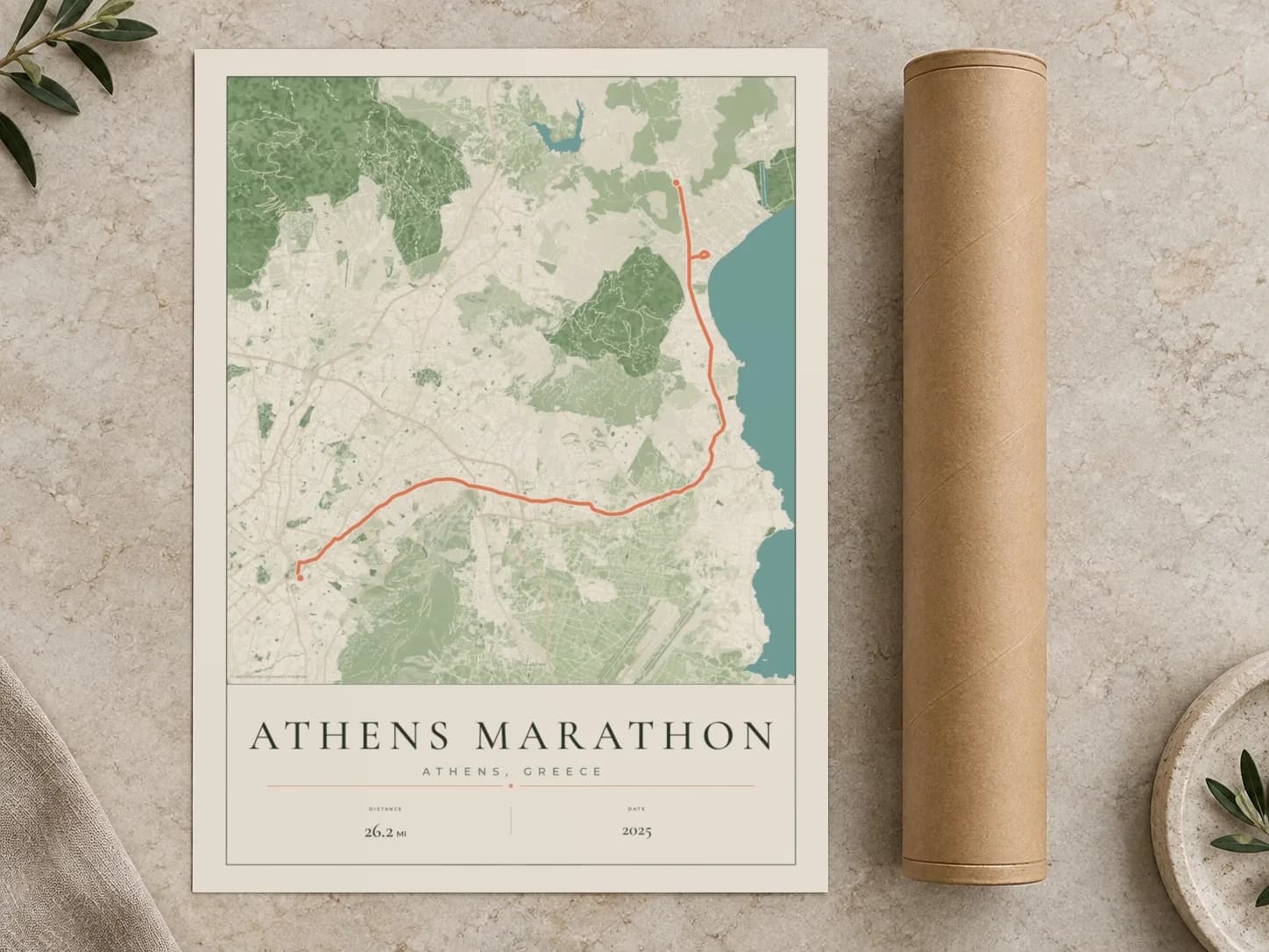 Cardboard postal tube beside a flat Athens Marathon route print