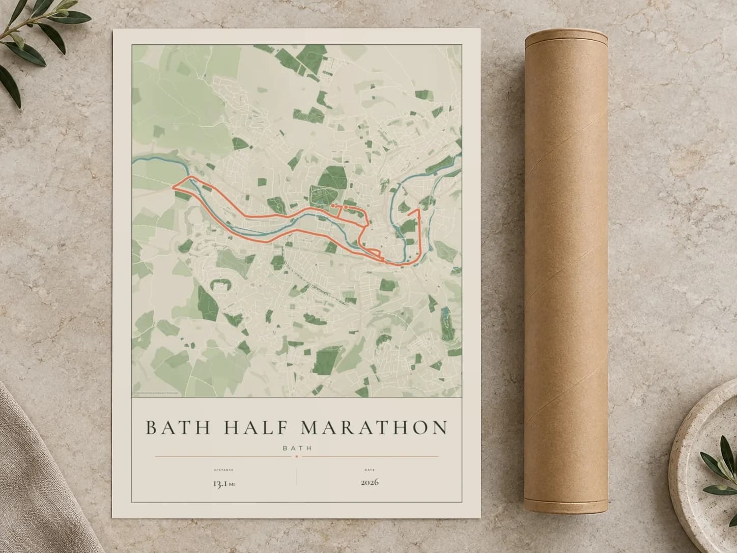 Cardboard postal tube beside a flat Bath Half Marathon route print