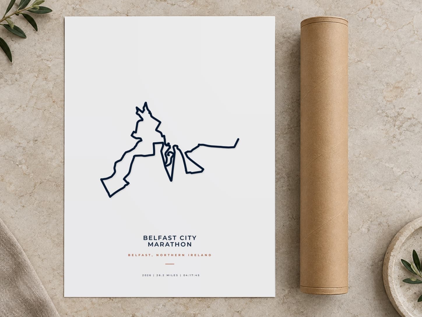 Cardboard postal tube beside a flat Belfast City Marathon route print