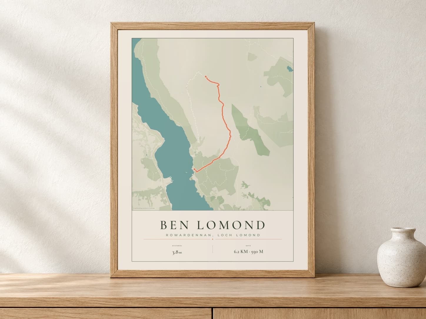 Ben Lomond Parkland route print in a light oak frame on a console