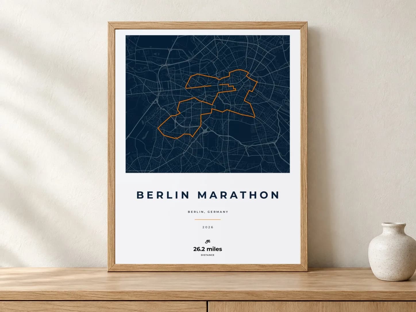 Berlin Marathon 2026 Race Blueprint route print in a light oak frame on a console