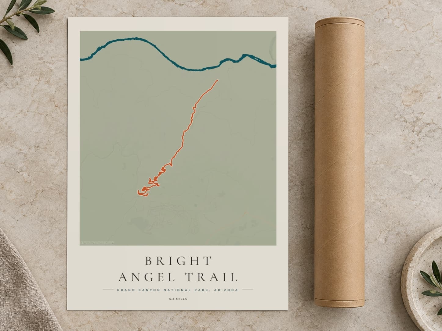 Cardboard postal tube beside a flat Bright Angel Trail route print