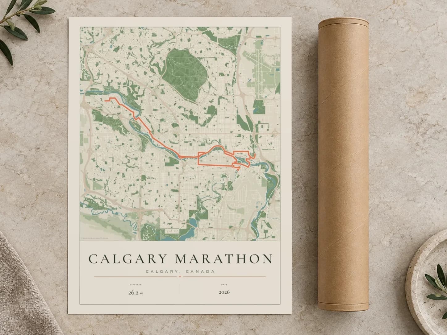 Cardboard postal tube beside a flat Calgary Marathon route print