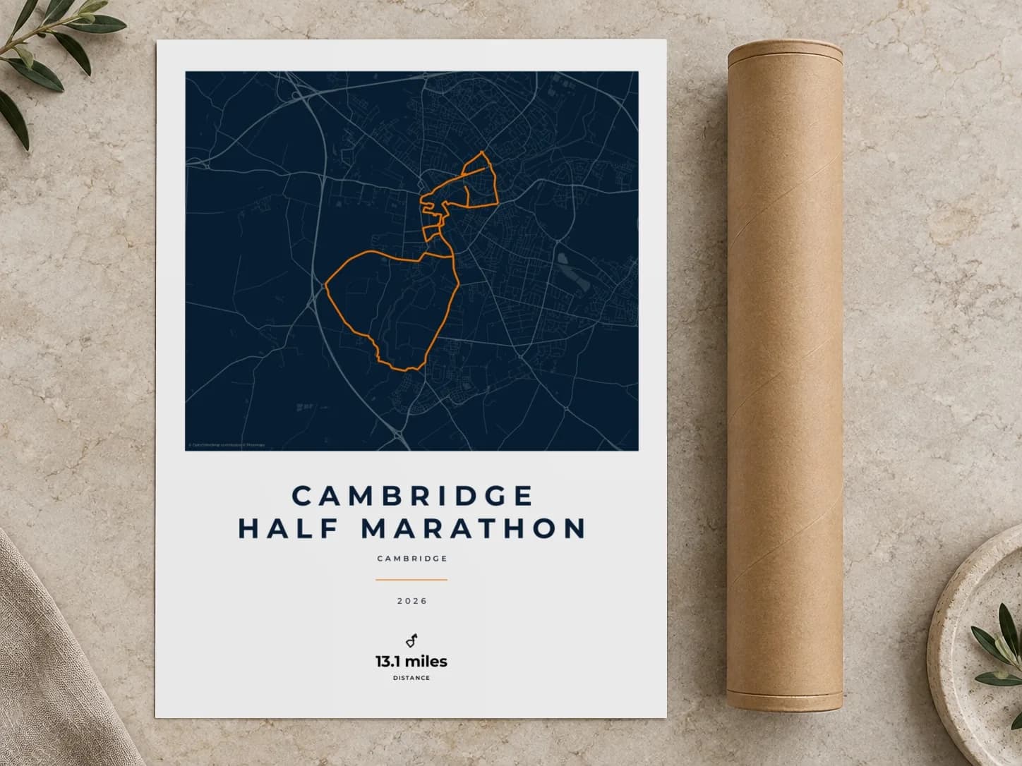 Cardboard postal tube beside a flat Cambridge Half Marathon route print