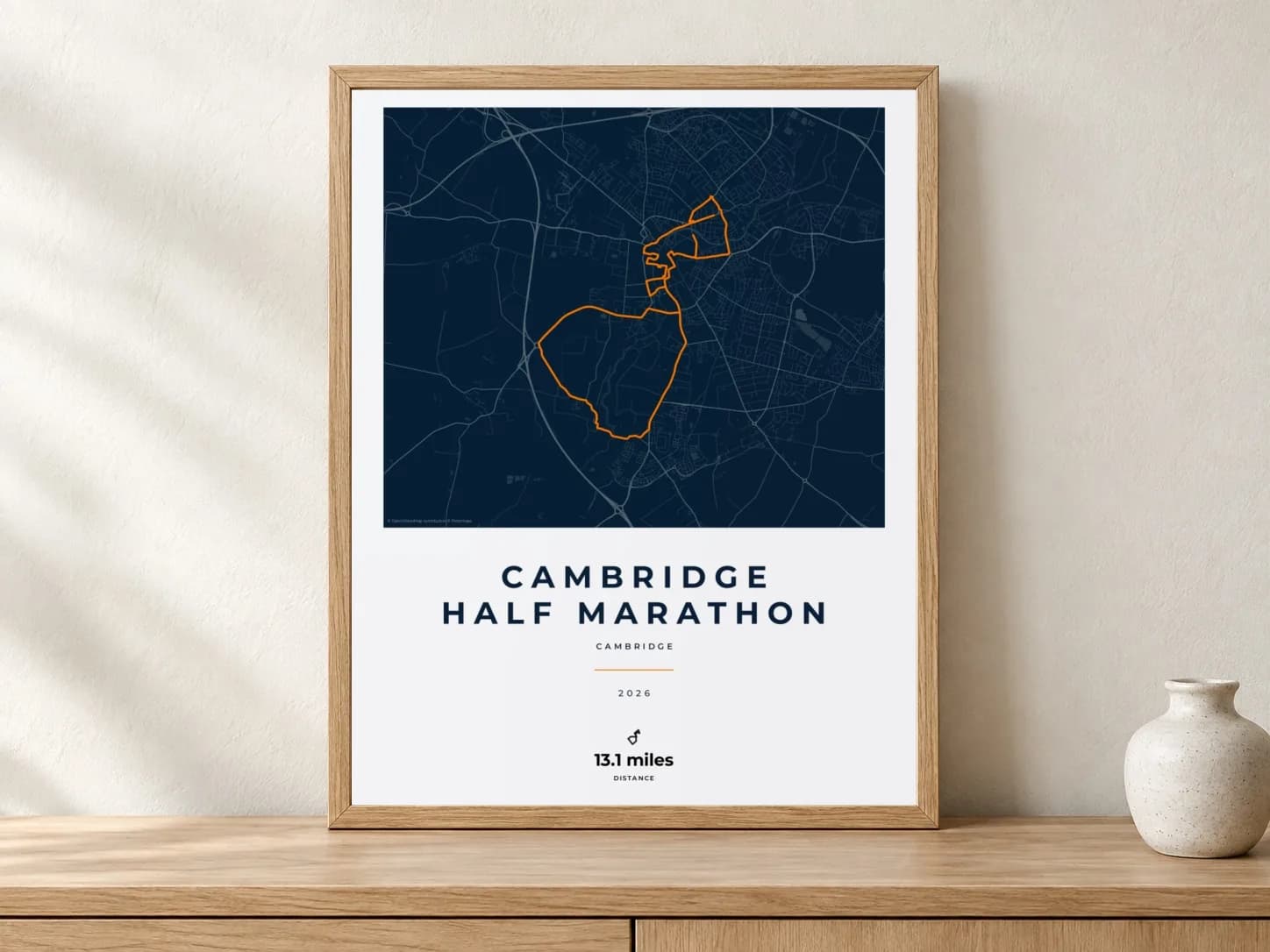 Cambridge Half Marathon 2026 Race Blueprint route print in a light oak frame on a console