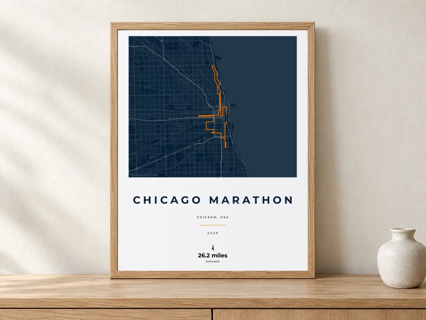 Chicago Marathon 2026 Race Blueprint route print in a light oak frame on a console