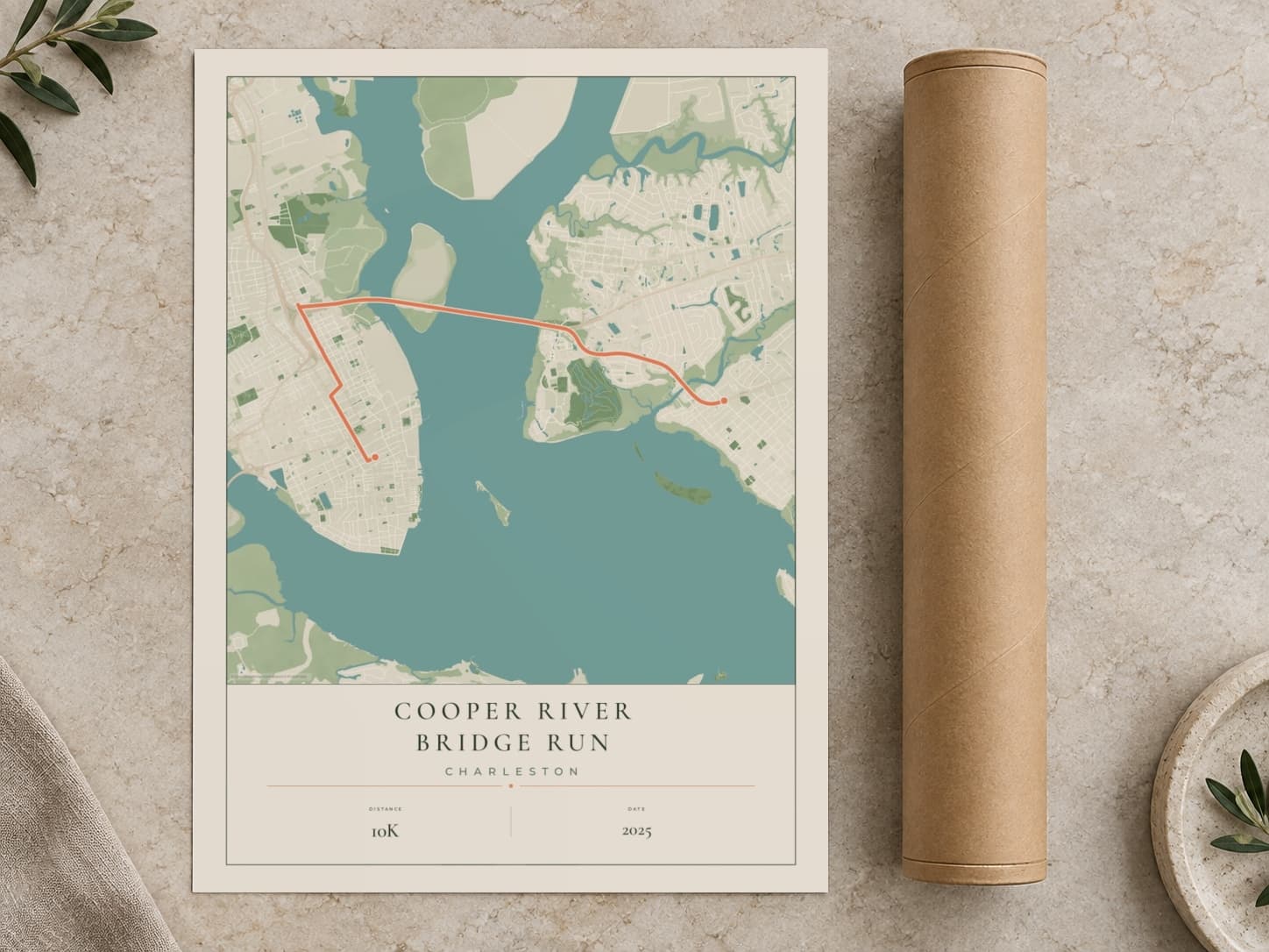 Cardboard postal tube beside a flat Cooper River Bridge Run route print