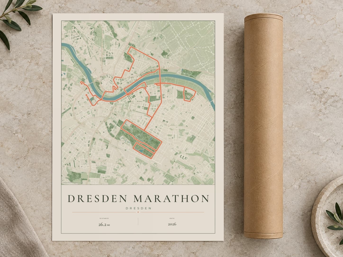 Cardboard postal tube beside a flat Dresden Marathon route print