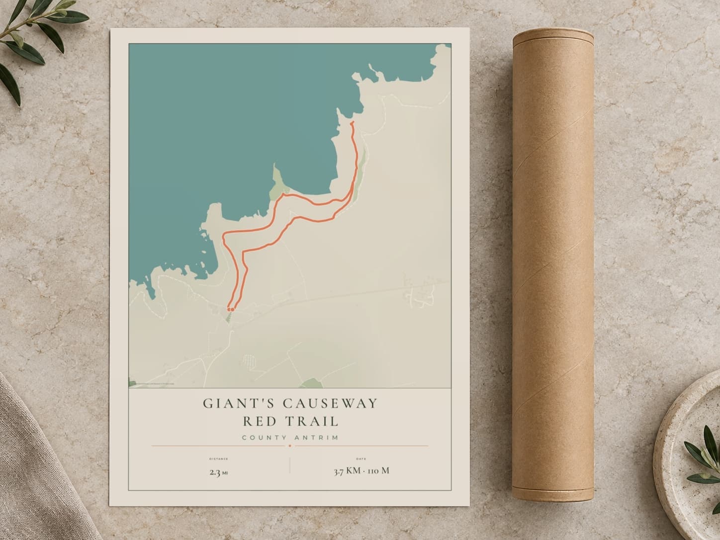 Cardboard postal tube beside a flat Giant's Causeway route print