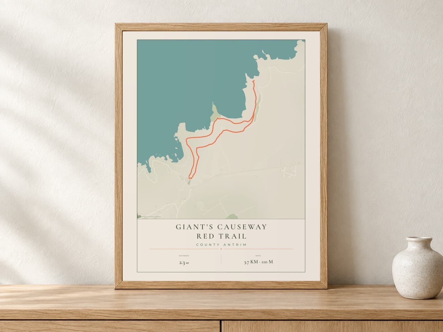 Giant's Causeway Parkland route print in a light oak frame on a console