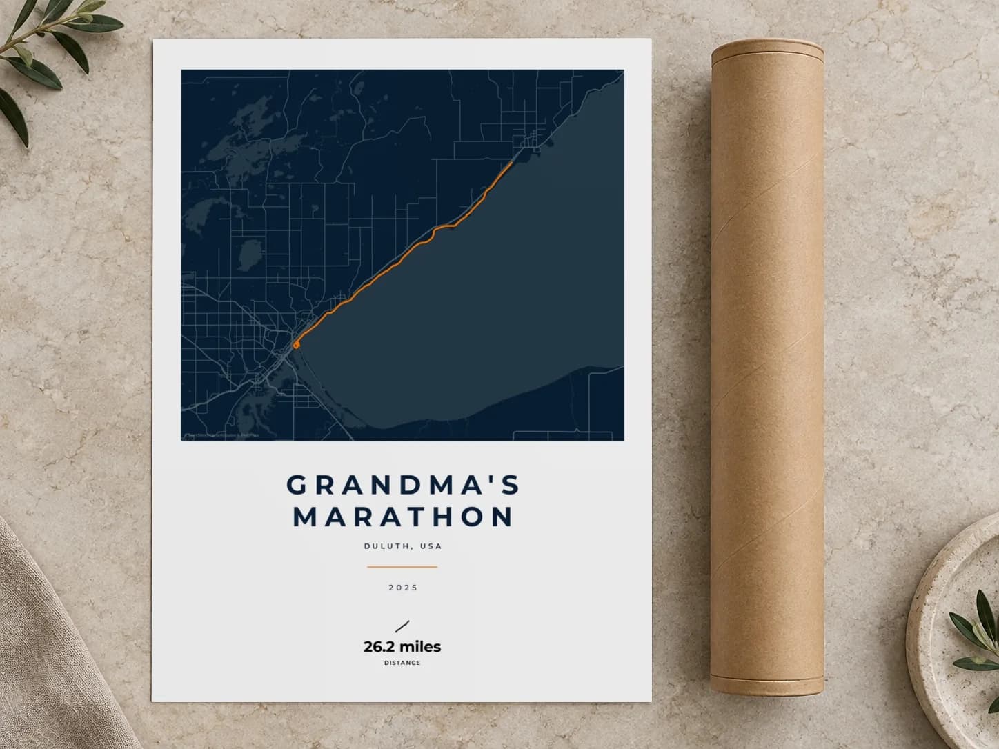 Cardboard postal tube beside a flat Grandma's Marathon route print