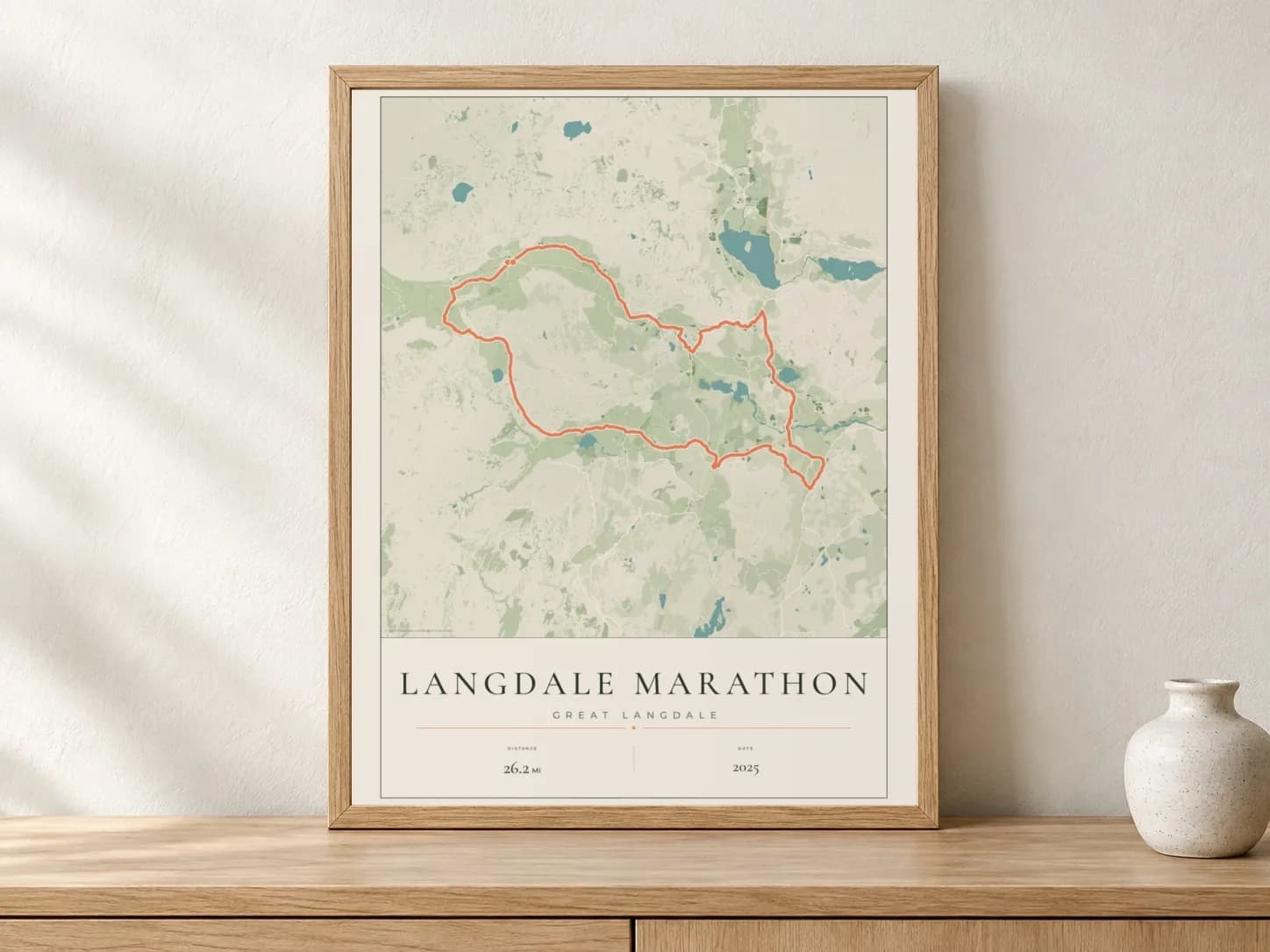 Langdale Marathon 2025 Parkland route print in a light oak frame on a console