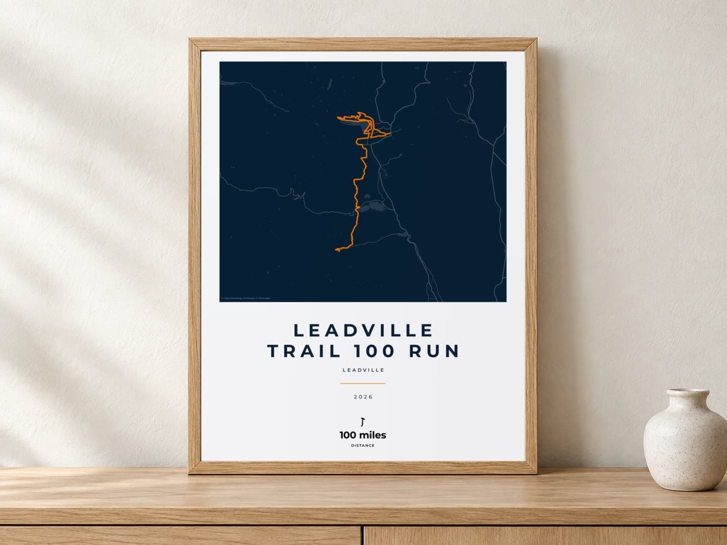 Leadville Trail 100 Run 2026 Race Blueprint route print in a light oak frame on a console