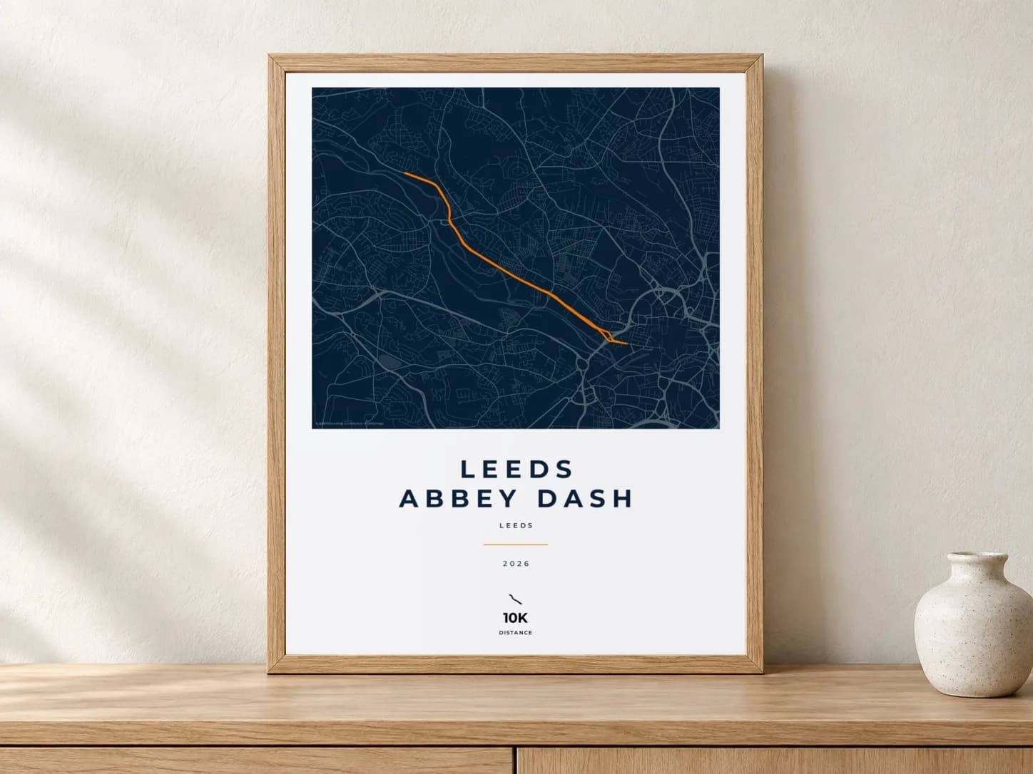 Leeds Abbey Dash Race Blueprint route print in a light oak frame on a console
