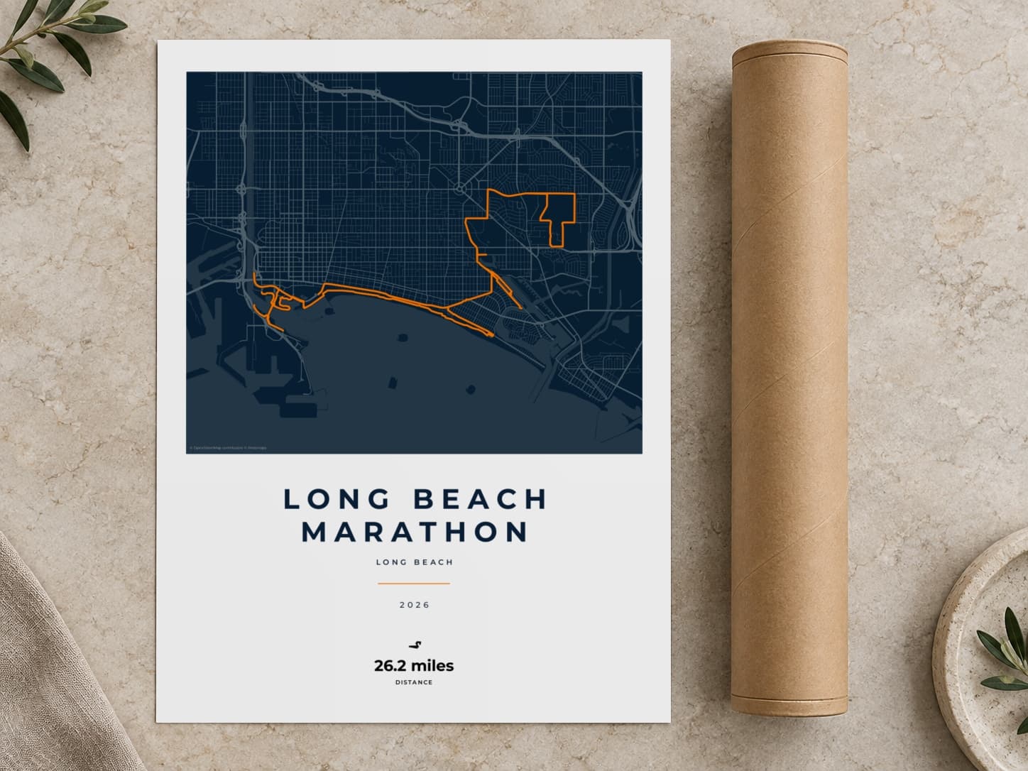 Cardboard postal tube beside a flat Long Beach Marathon route print