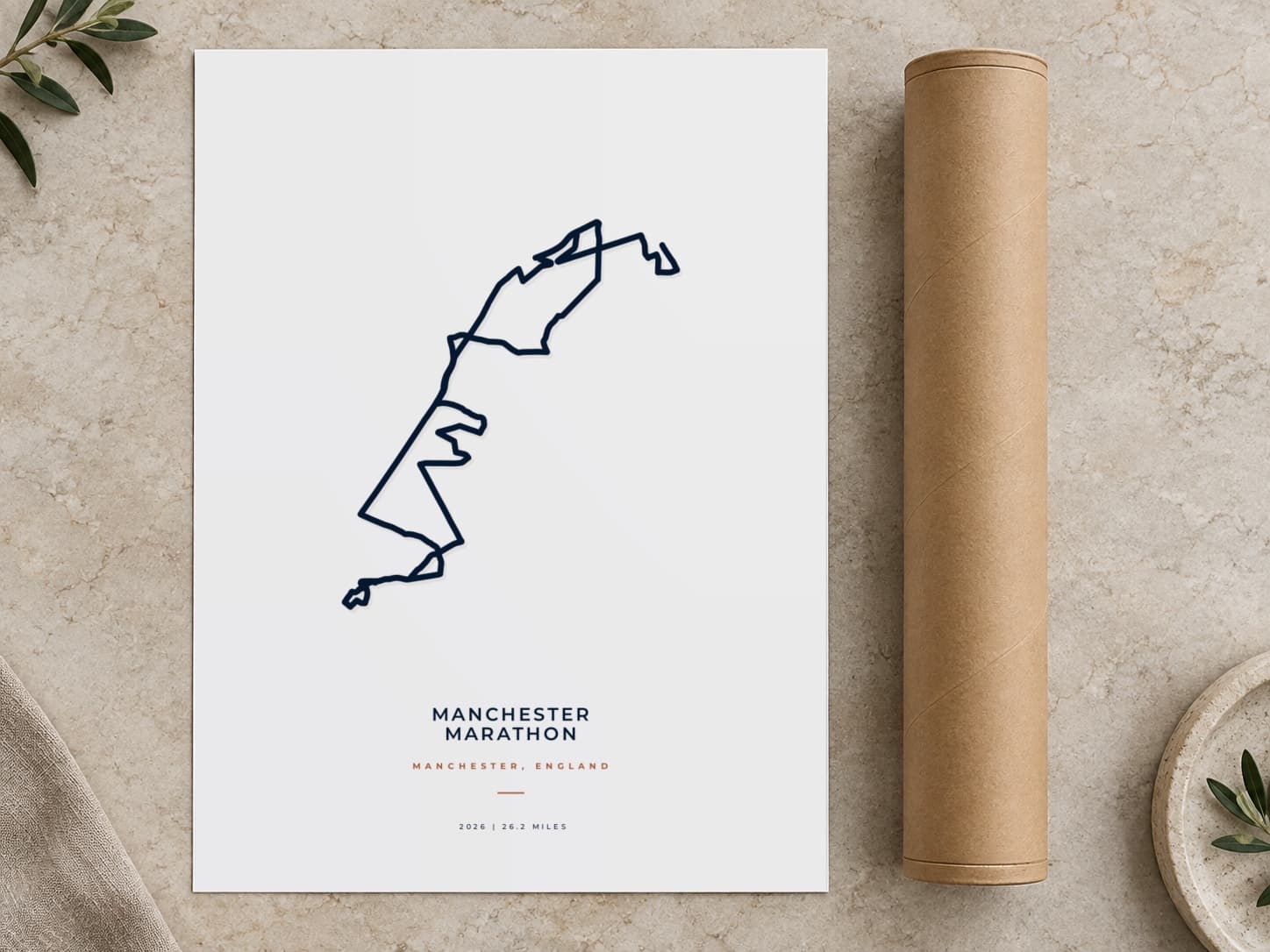 Cardboard postal tube beside a flat Manchester Marathon route print