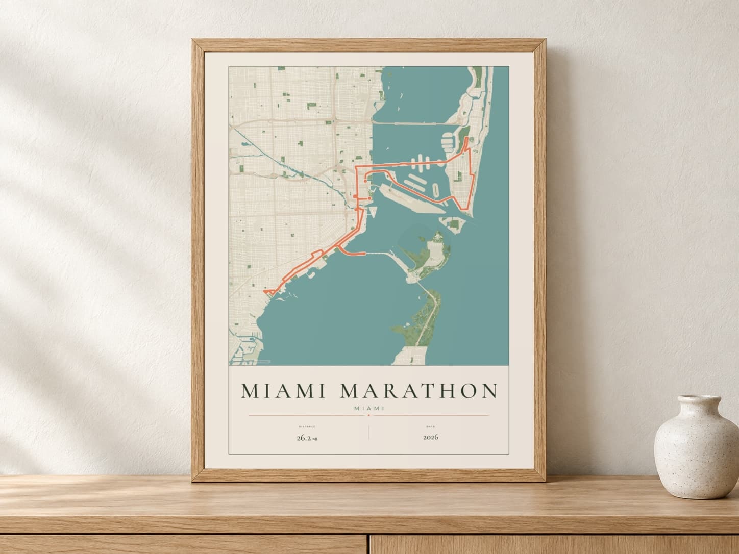 Miami Marathon 2026 Parkland route print in a light oak frame on a console