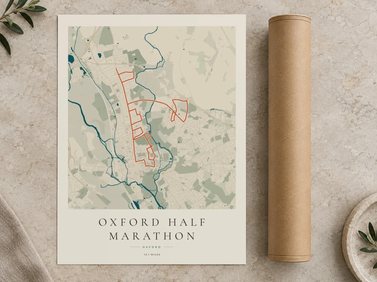 Cardboard postal tube beside a flat Oxford Half Marathon route print