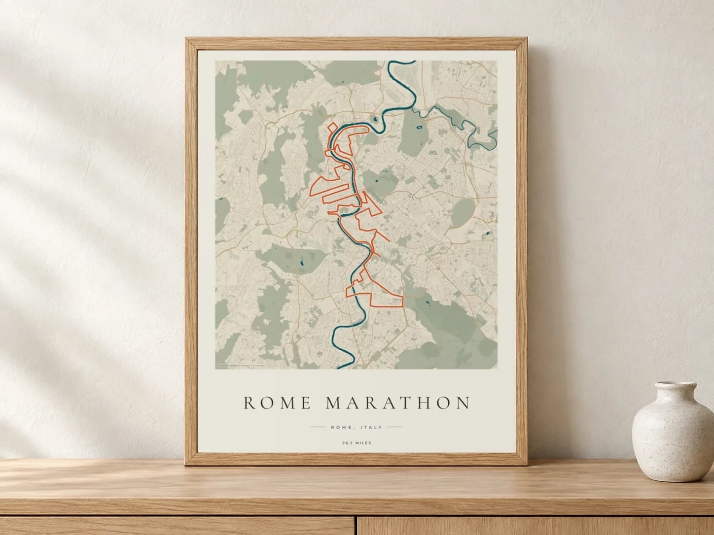 Rome Marathon 2026 Coastal Atlas route print in a light oak frame on a console