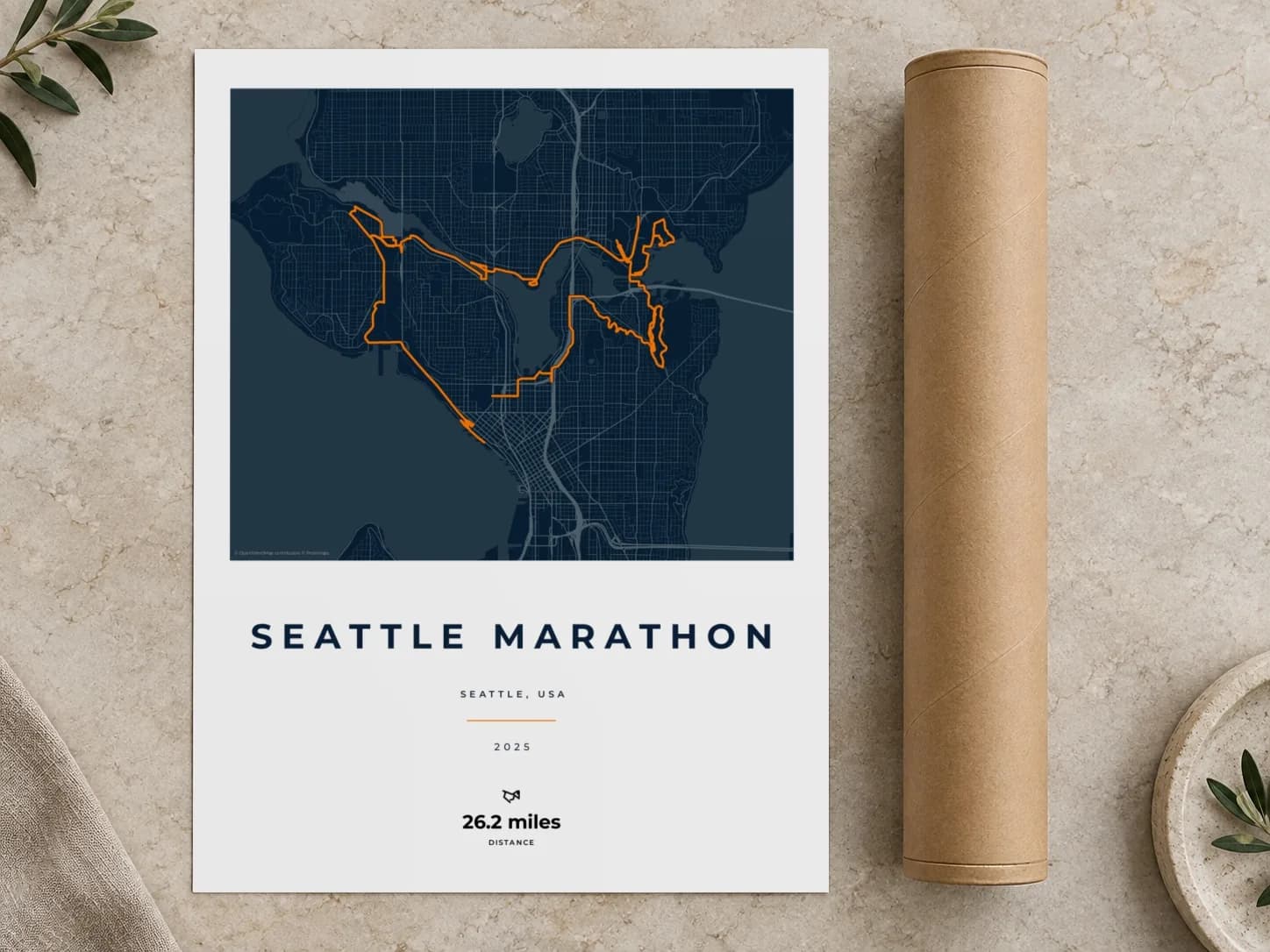 Cardboard postal tube beside a flat Seattle Marathon route print