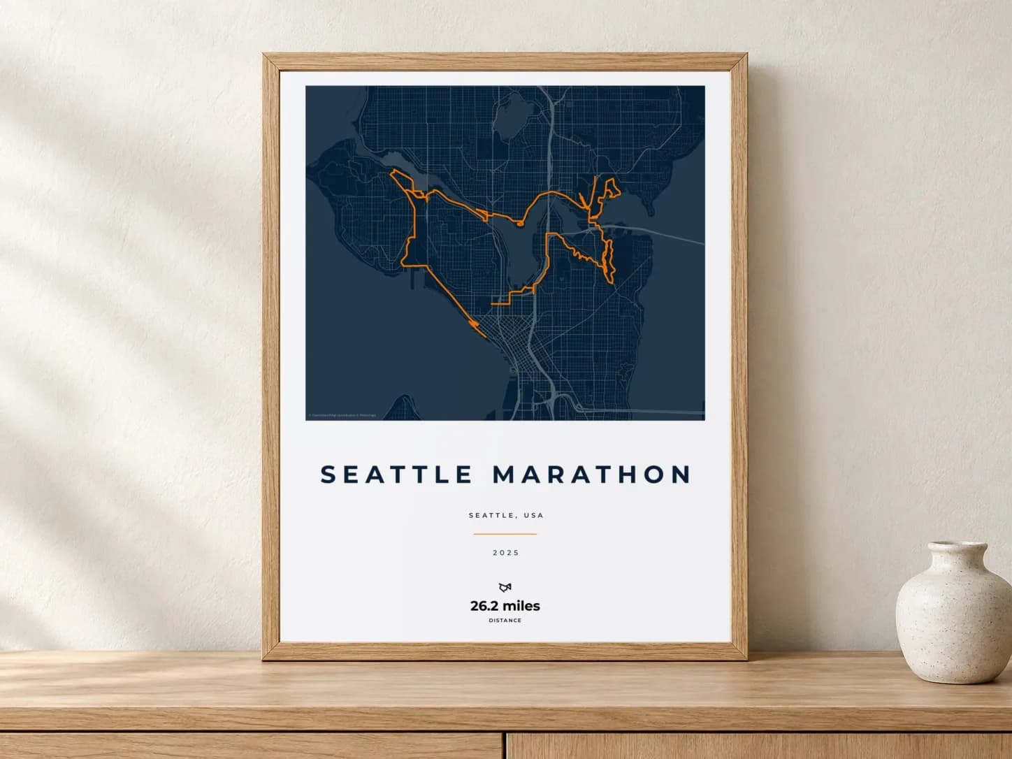 Seattle Marathon 2025 Race Blueprint route print in a light oak frame on a console
