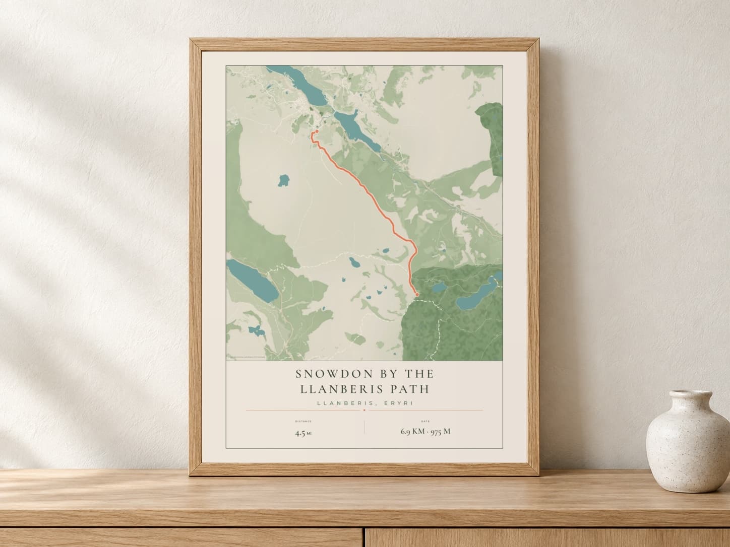 Snowdon Parkland route print in a light oak frame on a console