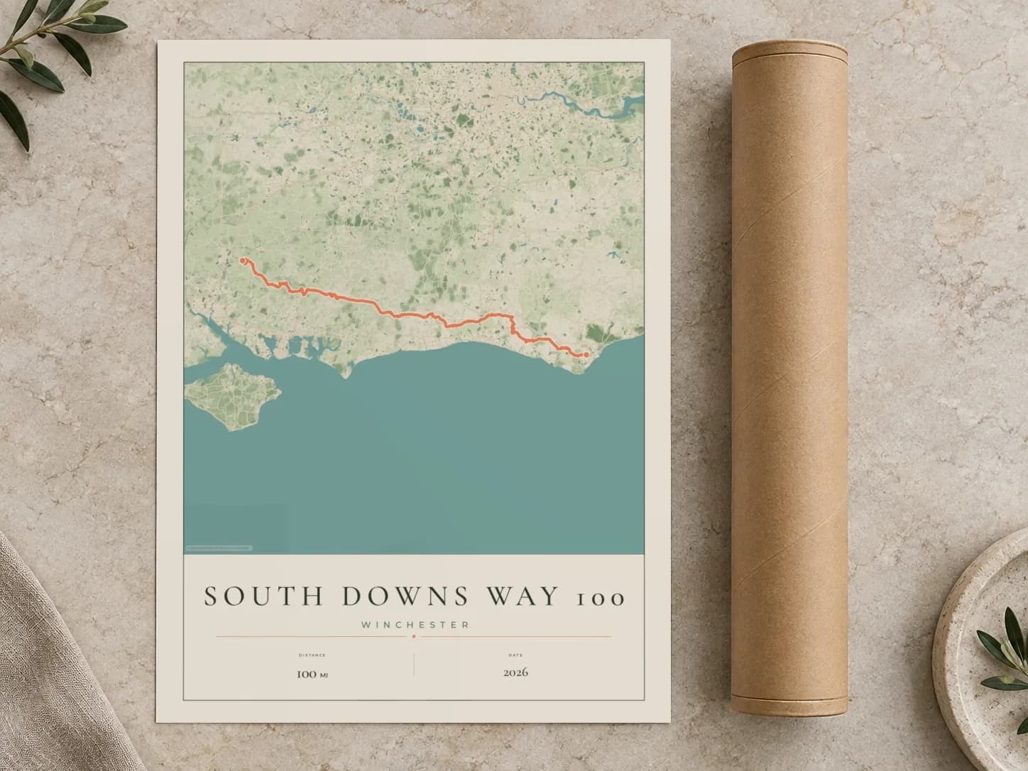 Cardboard postal tube beside a flat South Downs Way 100 route print