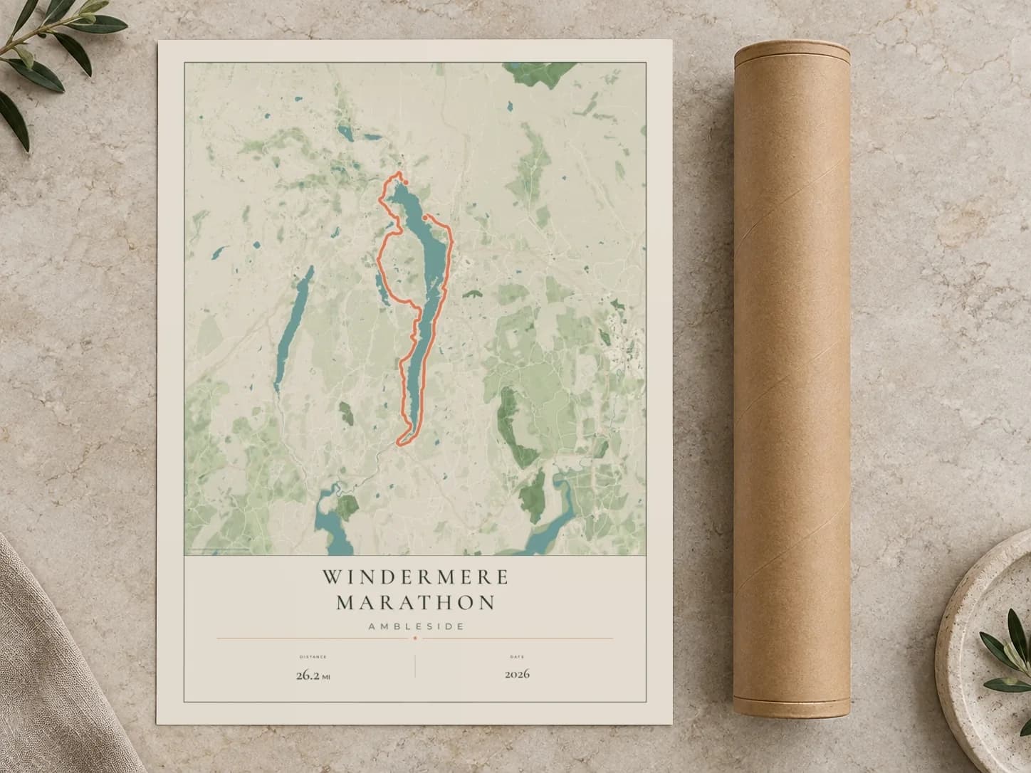 Cardboard postal tube beside a flat Windermere Marathon route print