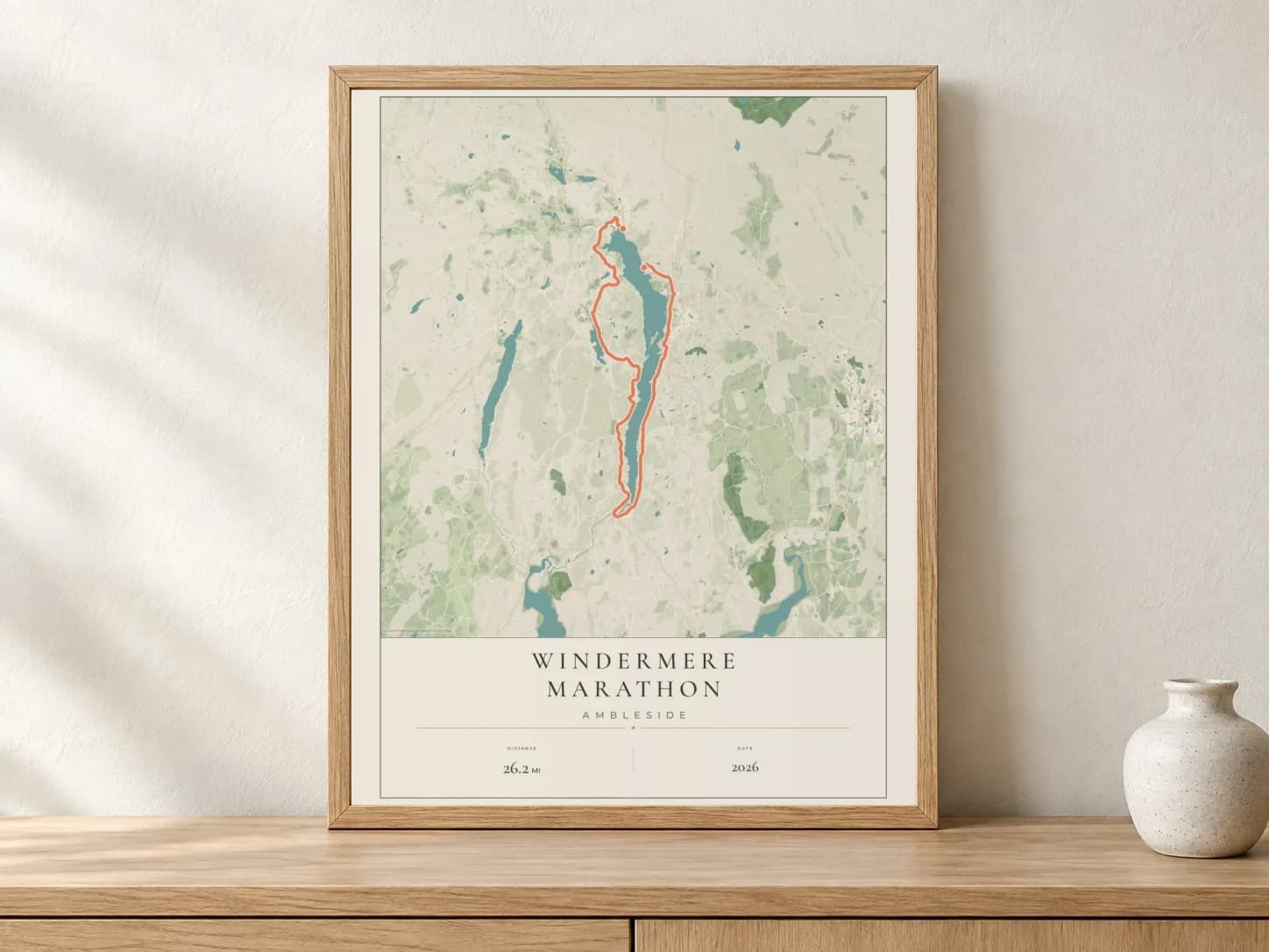 Windermere Marathon 2026 Parkland route print in a light oak frame on a console
