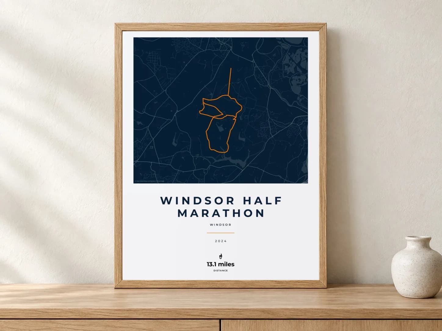 Windsor Half Marathon 2024 Race Blueprint route print in a light oak frame on a console
