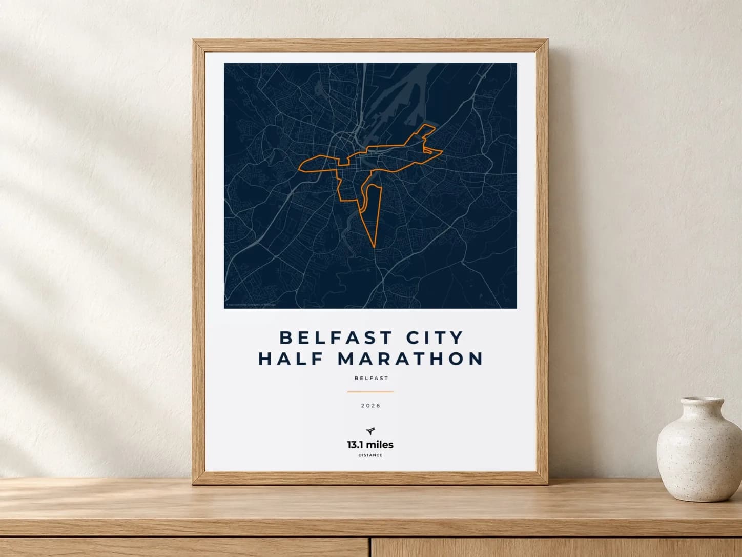 Belfast City Half Marathon 2026 Race Blueprint route print in a light oak frame on a console