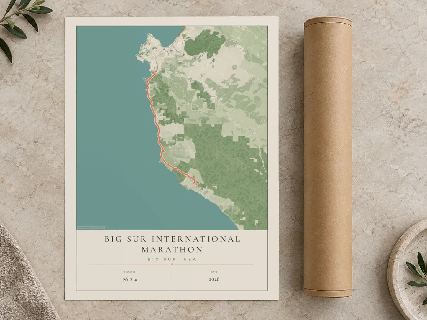 Cardboard postal tube beside a flat Big Sur International Marathon route print