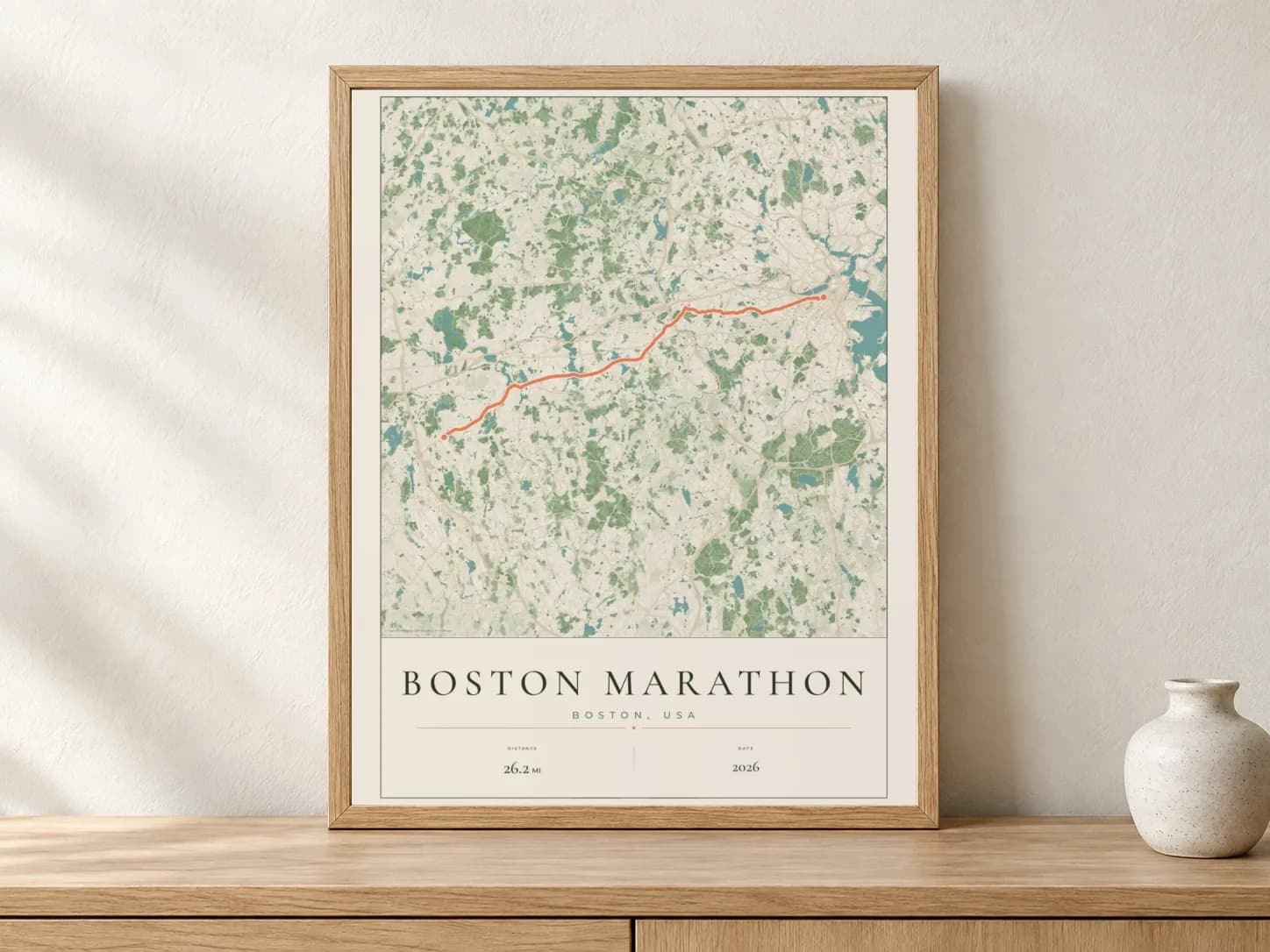 Boston Marathon 2026 Parkland route print in a light oak frame on a console