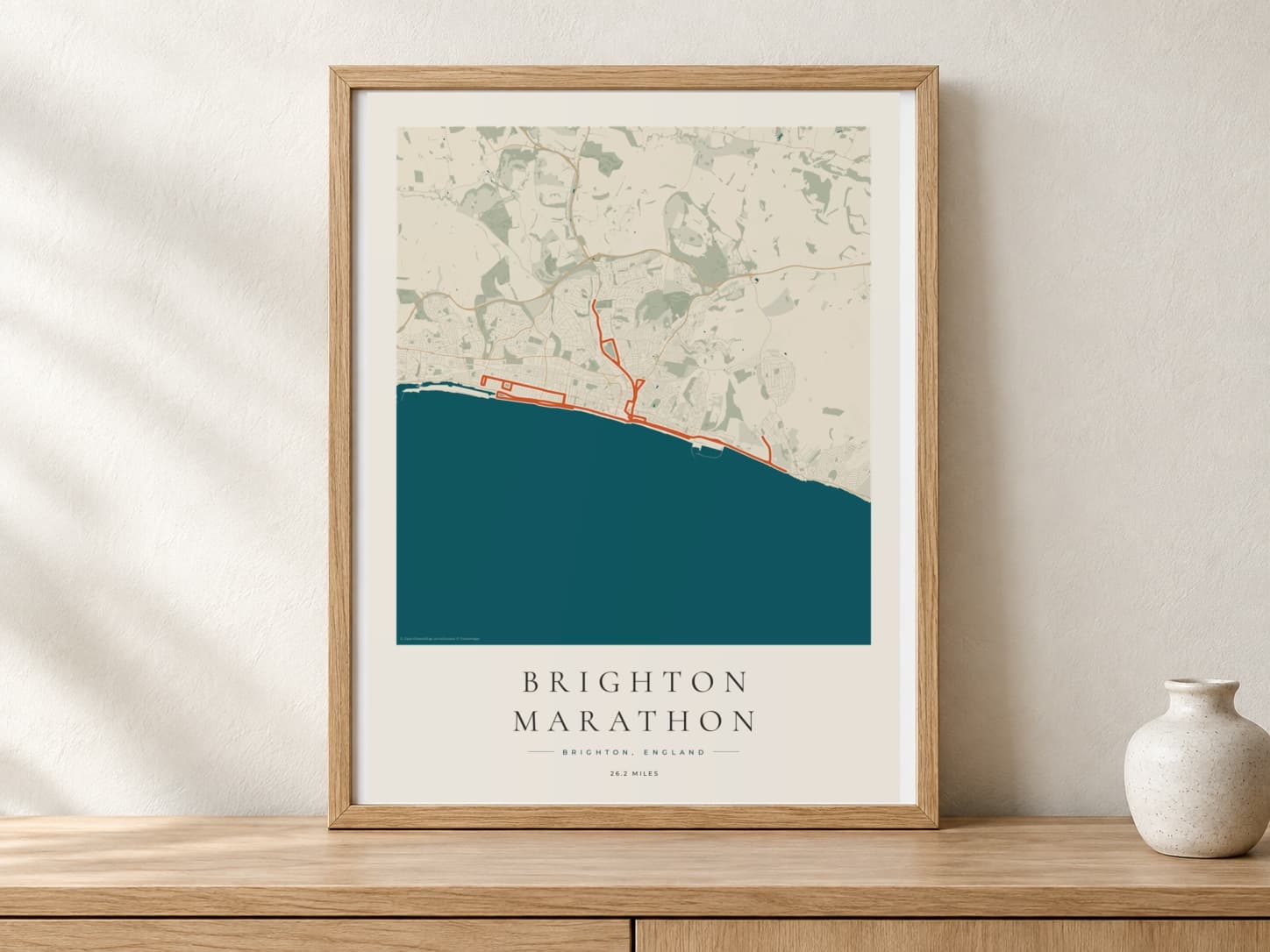 Brighton Marathon 2026 Coastal Atlas route print in a warm framed display scene
