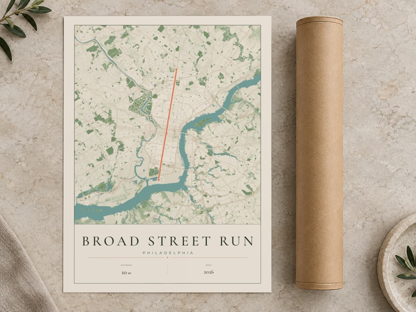 Cardboard postal tube beside a flat Broad Street Run route print