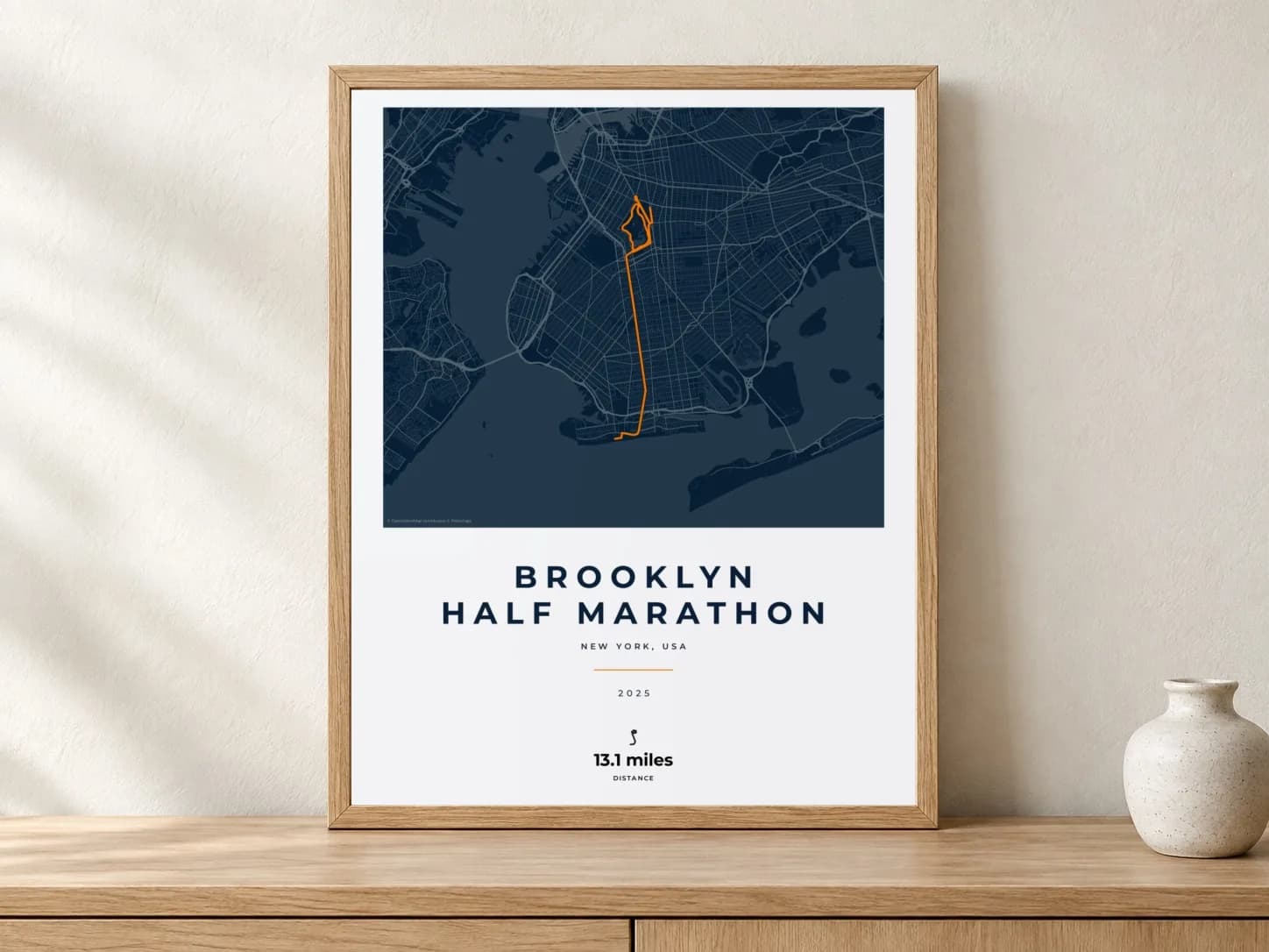 Brooklyn Half Marathon 2025 Race Blueprint route print in a light oak frame on a console