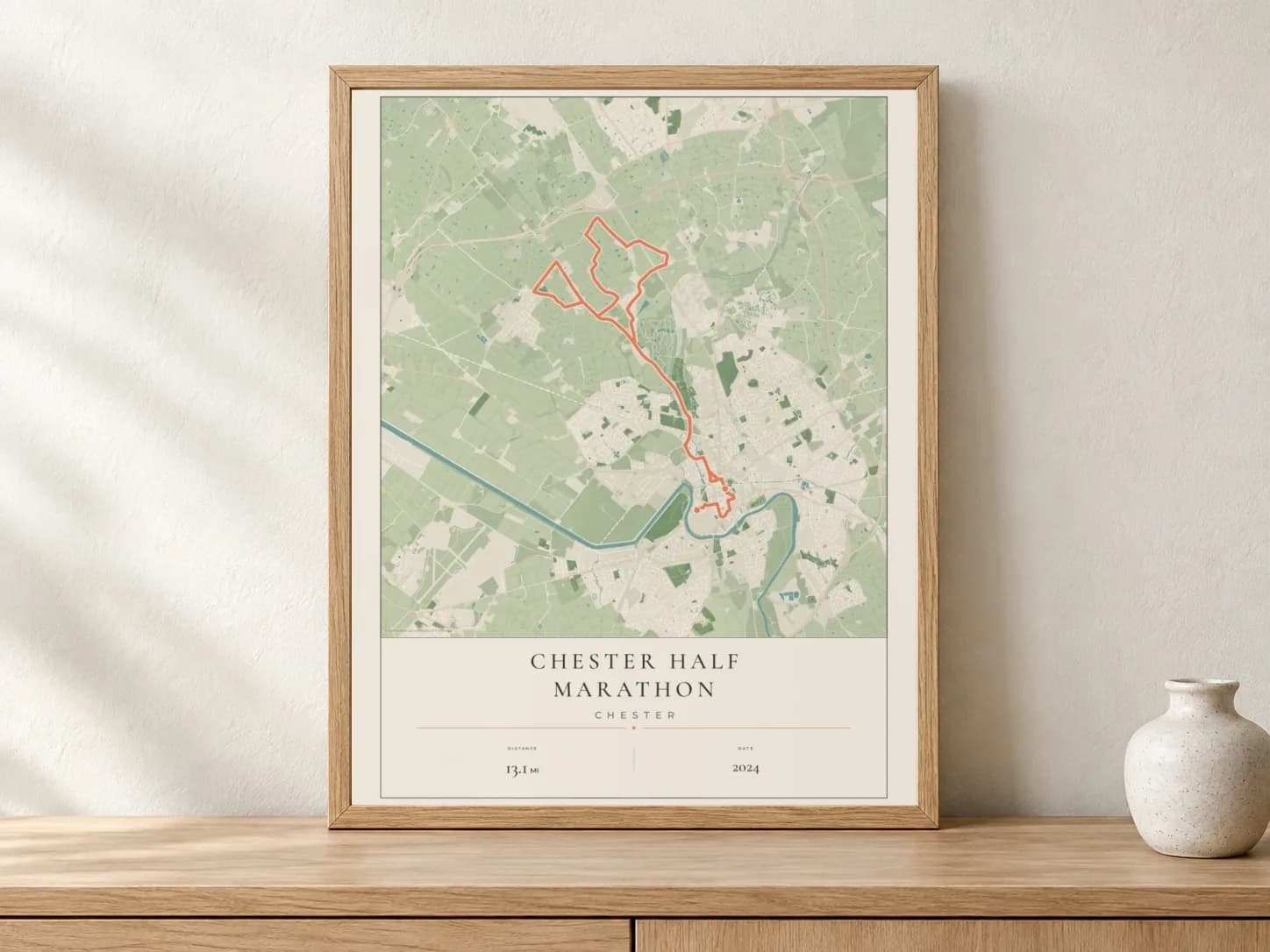 Chester Half Marathon 2024 Parkland route print in a light oak frame on a console