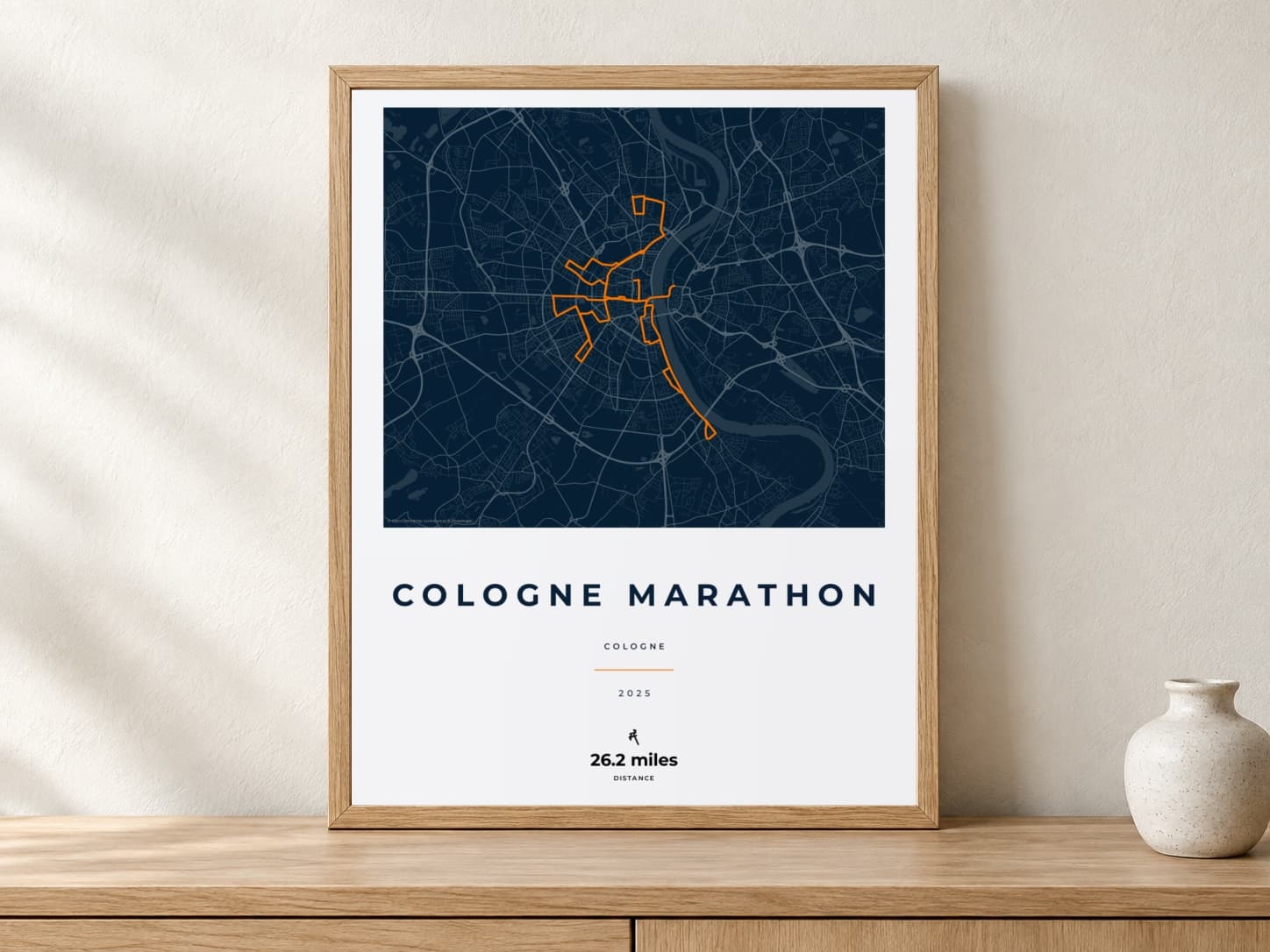 Cologne Marathon 2025 Race Blueprint route print in a light oak frame on a console