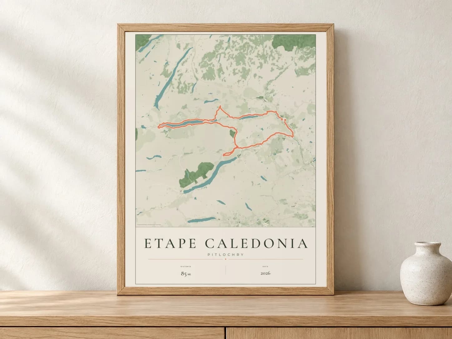 Etape Caledonia 2026 Parkland route print in a light oak frame on a console