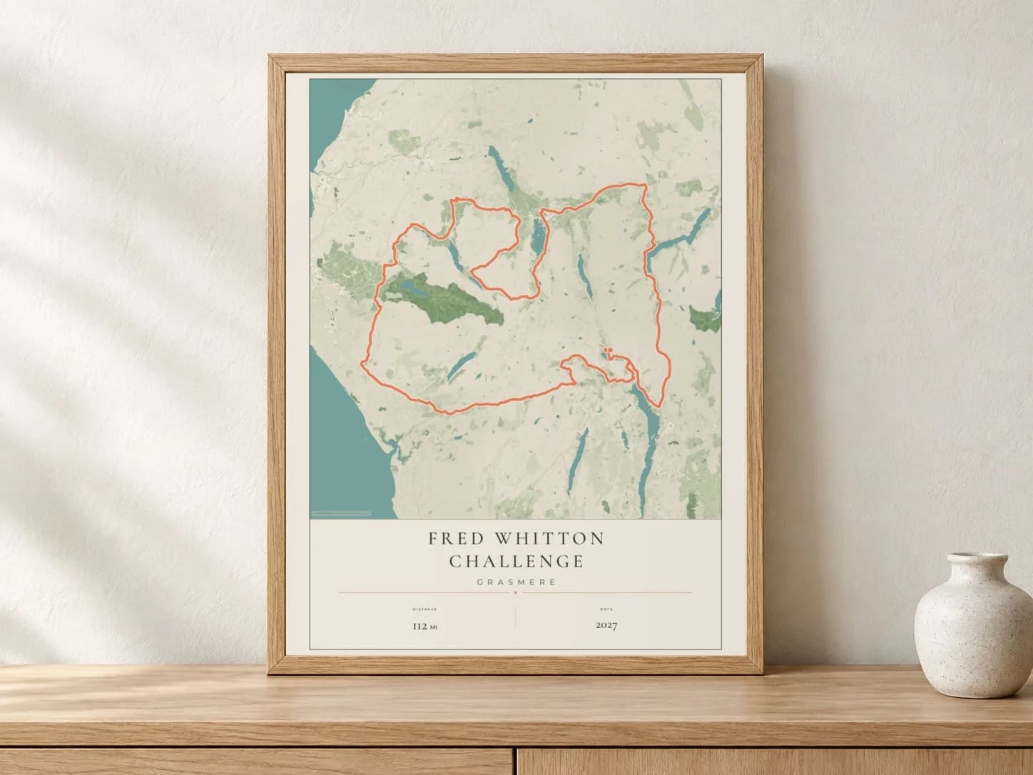 Fred Whitton Challenge 2027 Parkland route print in a light oak frame on a console