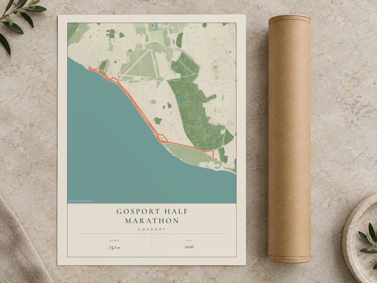 Cardboard postal tube beside a flat Gosport Half Marathon route print
