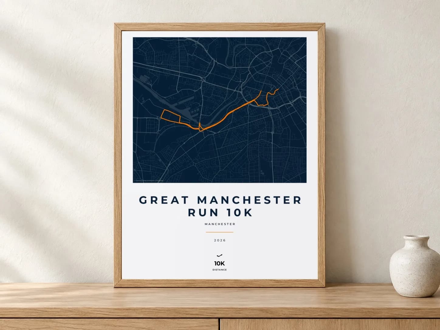 Great Manchester Run 10K 2026 Race Blueprint route print in a light oak frame on a console