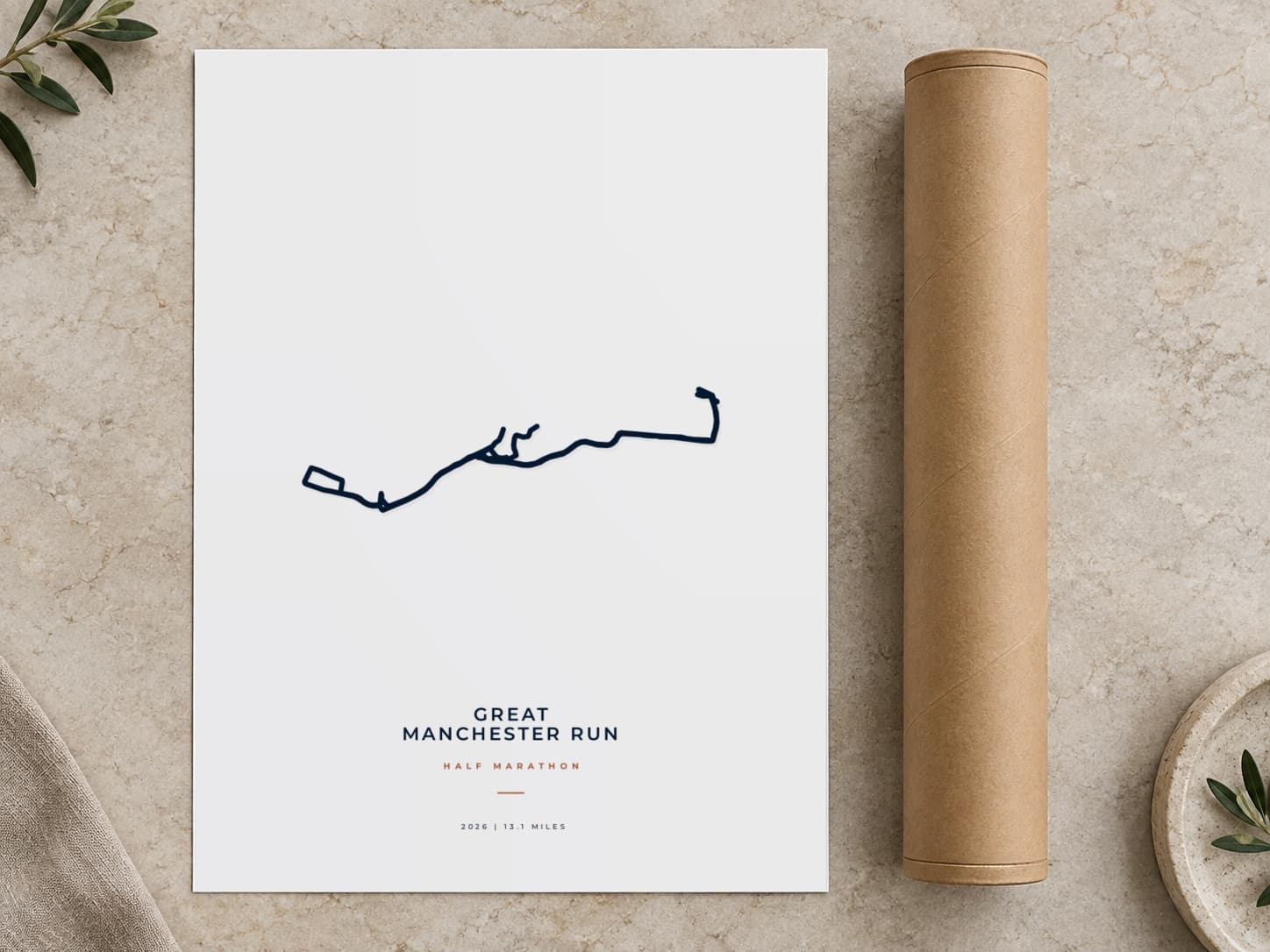 Cardboard postal tube beside a flat Great Manchester Run Half Marathon route print