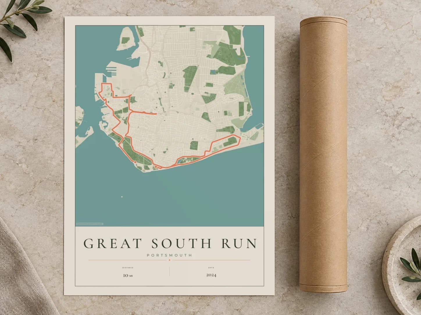 Cardboard postal tube beside a flat Great South Run route print