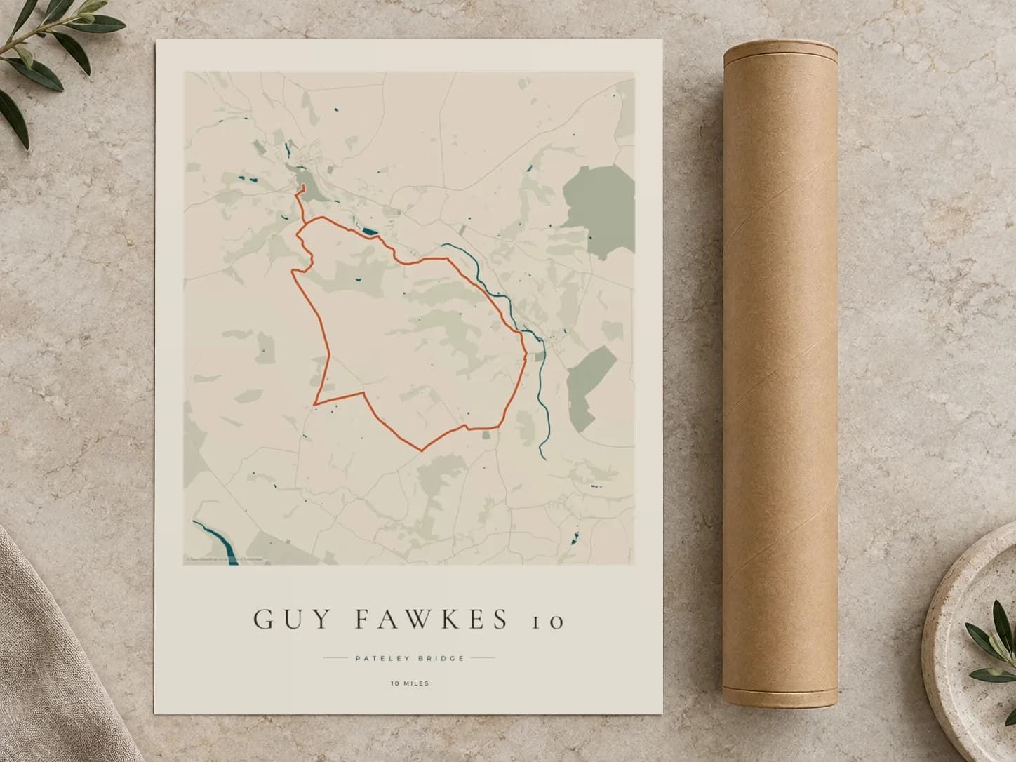 Cardboard postal tube beside a flat Guy Fawkes 10 route print