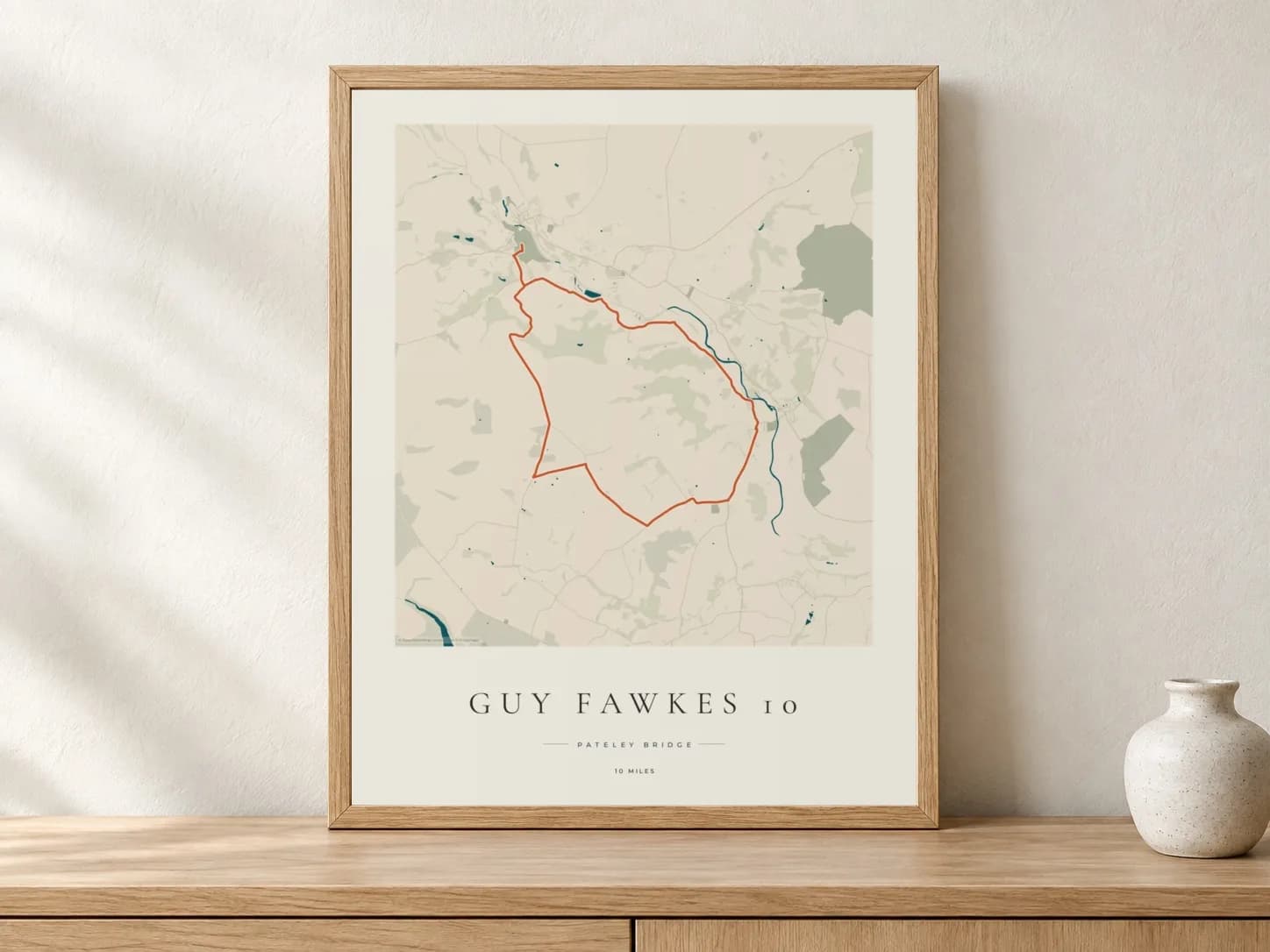 Guy Fawkes 10 Coastal Atlas route print in a light oak frame on a console