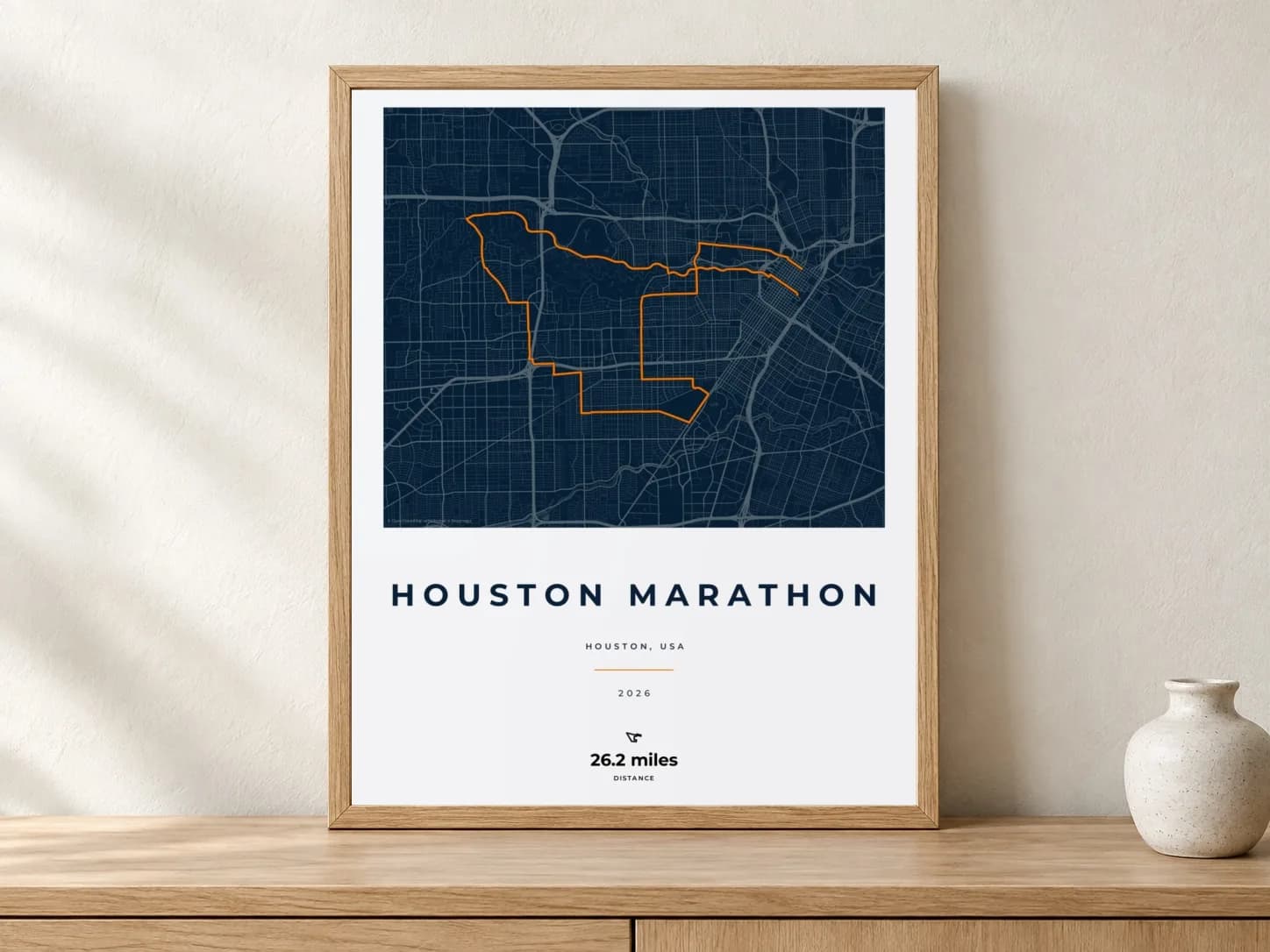 Houston Marathon 2026 Race Blueprint route print in a light oak frame on a console