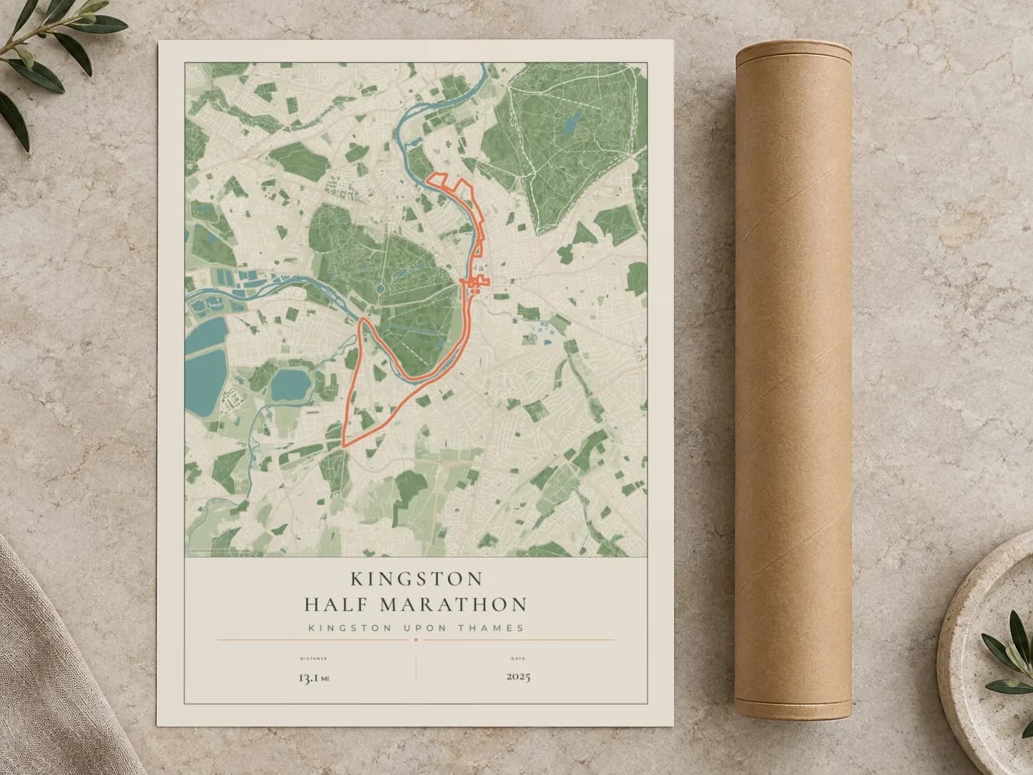 Cardboard postal tube beside a flat Kingston Half Marathon route print