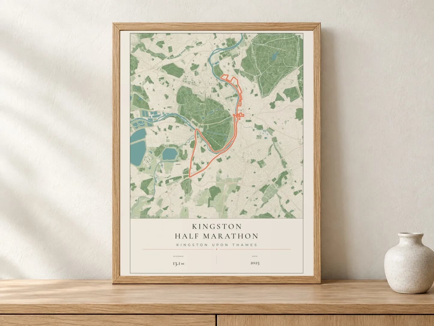 Kingston Half Marathon 2025 Parkland route print in a light oak frame on a console
